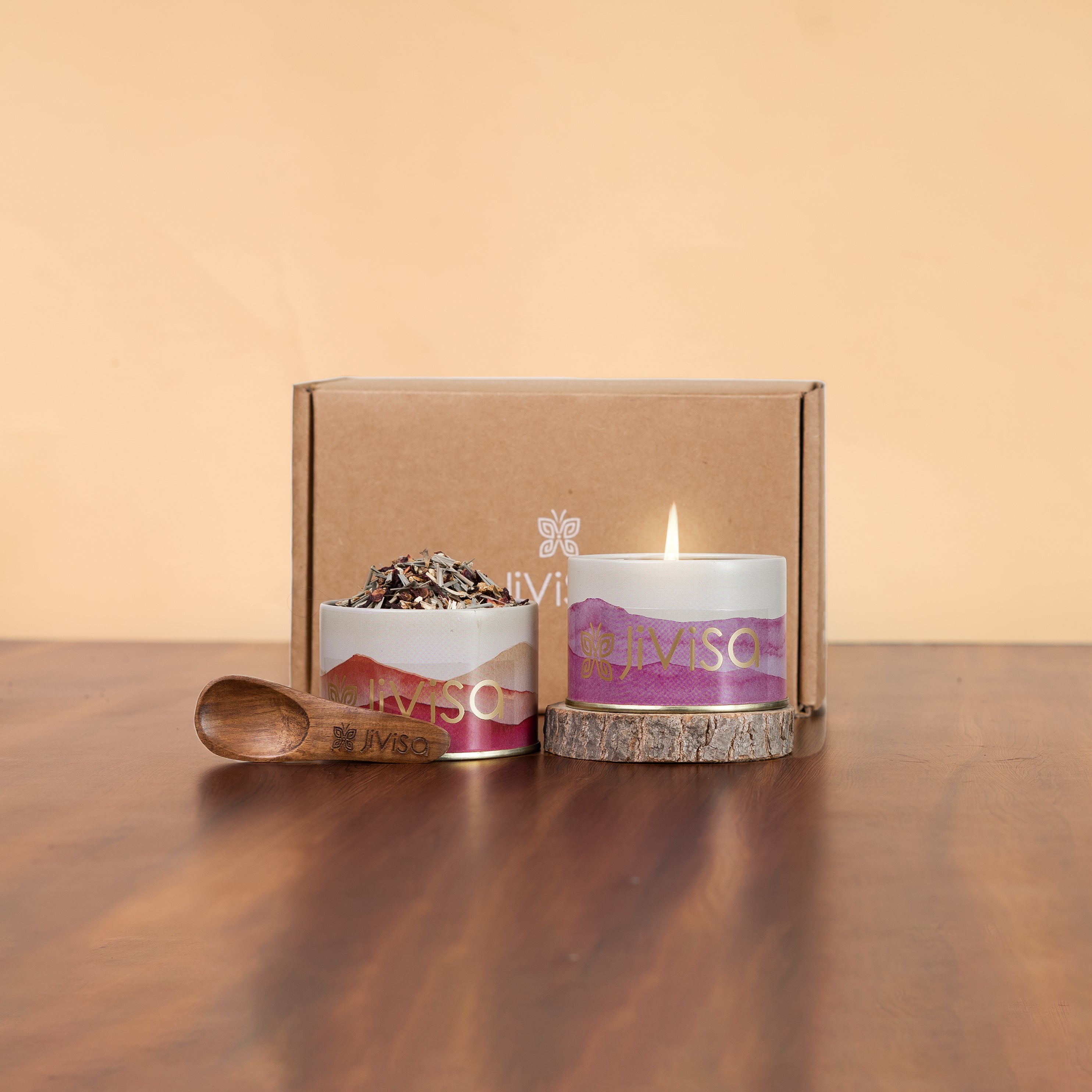 Tranquil Himalayan Collection Gift Box - JiViSa. Two jars of an Herbal tea blend and a wax candle with decorative label placed in front of the gift box.