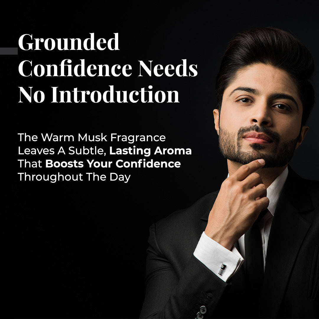 Image features a man in a black suit with a white shirt, touching his chin, looking confidently on a black background. Tagline: "Grounded Confidence Needs No Introduction". Text describe JiViSa Charcoal Musk Ayurvedic soap benefits: The Warm Musk Fragrance Leaves a Subtle, Lasting Aroma That Boosts Your Confidence Throughout the Day.