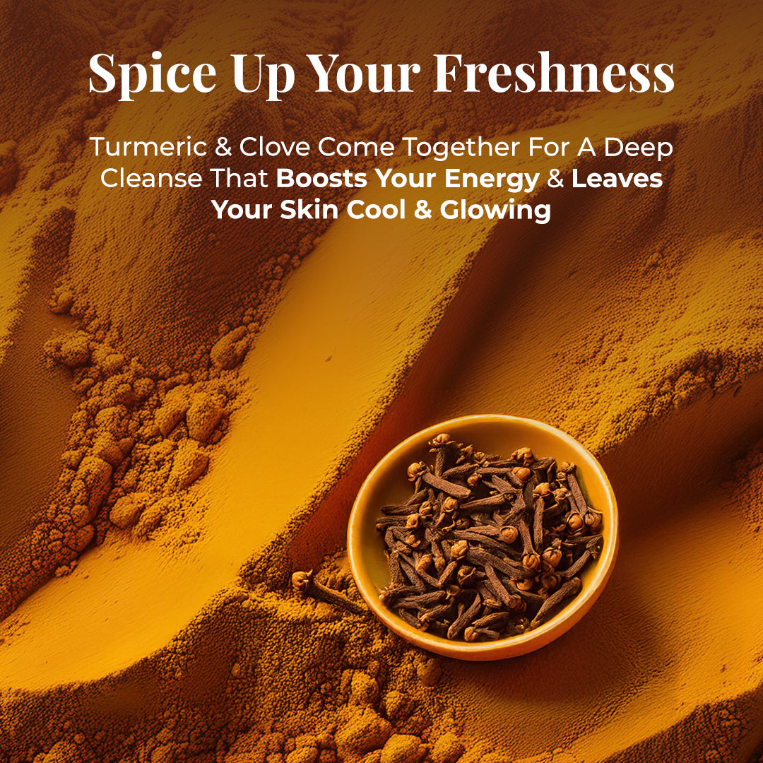 An overhead shot of vibrant orange turmeric powder with a small yellow bowl filled with dried cloves in the bottom right corner. Tagline: Spice Up Your Freshness. Text highlights Turmeric & Clove Come Together For A Deep Cleanse That Boosts Your Energy & Leaves Your Skin Cool & Glowing.