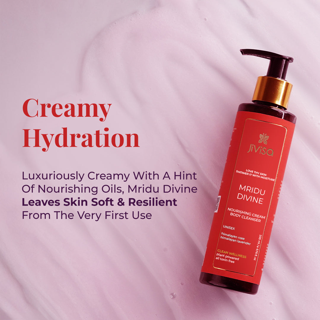 Image features JiViSa Mridu Divine Body Cleanser Bottle placed on a pastel-colored creamy texture background with a heading reads "Creamy Hydration" followed by text describe it as the Luxuriously creamy with a hint of nourishing oils, Mridu Divine Leaves Skin Soft & Resilient from the very first use.