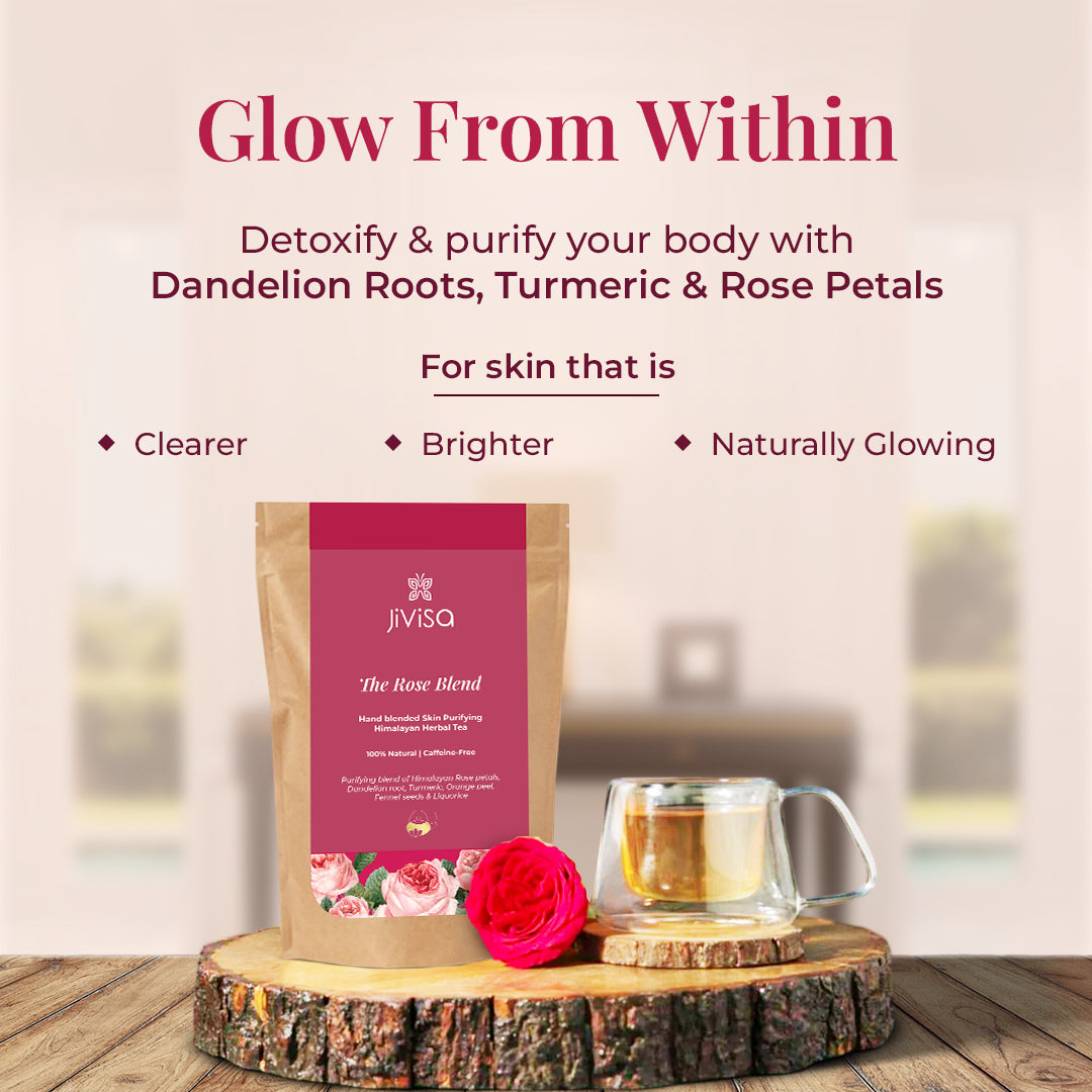 Pouch of JiViSa- The Rose Blend herbal Tea along with a glass mug filled with Rose Blend Herbal tea, a fresh pink rose is placed at the base of the package, and the setup rests on a rustic wooden slice, giving a natural and earthy feel. The tagline reads "Glow From Within" by helping to Detoxify & purify your body with Dandelion Roots, Turmeric & Rose Petals for skin that is Clearer, Brighter, and Naturally Glowing.