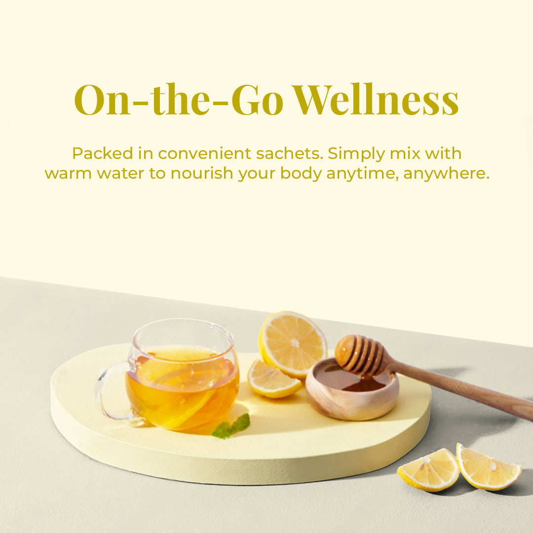 Image displays a clear glass cup filled with JiViSa-The Nectar of Life Immunity Infusion, alongside a small wooden bowl of honey with a dipper, and several lemon slices, all arranged on a light-colored circular, tray. The text above reads: "On-the-Go Wellness," and below its text describing JiViSa Instant Immunity Infusion features: Packed in convenient sachets. Simply mix with warm water to nourish your body anytime, anywhere.