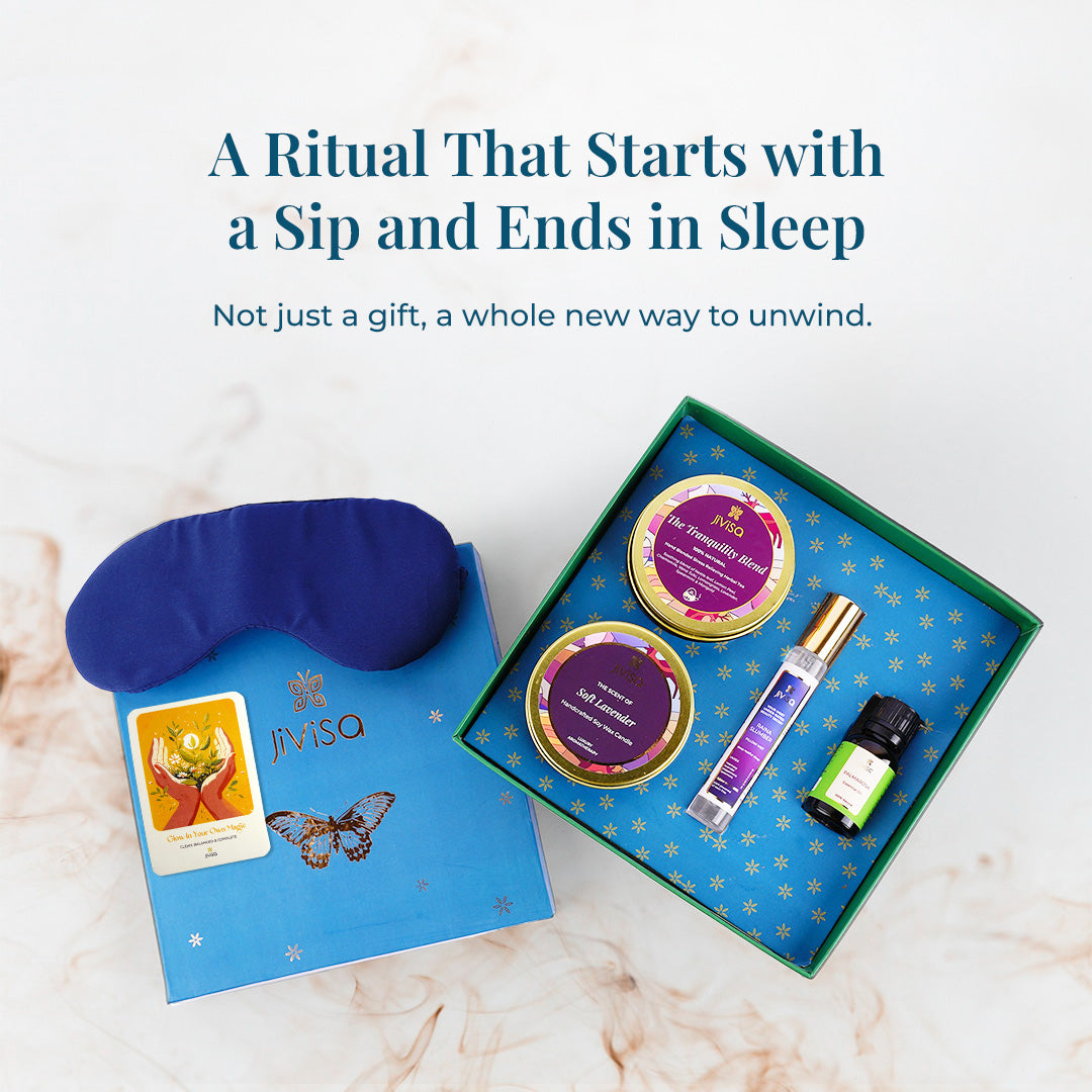 A top-down view of the open JiViSa Dreamscape Relaxation Aroma Gift Set, revealing all JiViSa self-care products beautifully arranged- Tranquility Blend Herbal Tea, Soft Lavender Candle, Raina Slumber Pillow Mist and a bottle of Palmarosa Essential Oil, eye mask is placed outside the box, and the handwritten gift card is placed on top of the box cover. The heading reads: "A Ritual That Starts with a Sip and Ends in Sleep" followed by a text which describe it is Not just a gift, a whole new way to unwind.