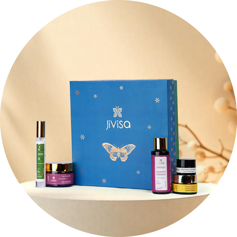 JiViSa skincare GIFT BOX products including a blue box, bottles, and jars on a beige background.