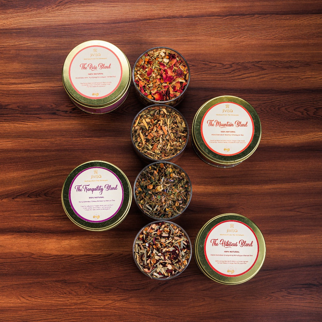 JiViSa Himalayan Discovery Tea Gift Box. The image showcases four distinct JiViSa herbal tea blends- The Rose Blend, The Mountain Blend, The Hibiscus Blend and The Tranquility Blend corresponding clear container displaying the loose-leaf tea inside.
