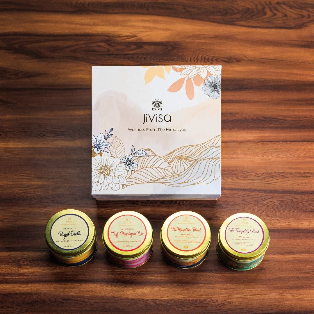 JiViSa Premium Loose Leaf Tea and Soy wax Candle Gift Box. Four round tins arranged in a front of the gift box: The teas are "The Mountain Blend," and "The Tranquility Blend," and Soy wax Candle are "Soft Himalayan Rose" and "Royal Oudh".