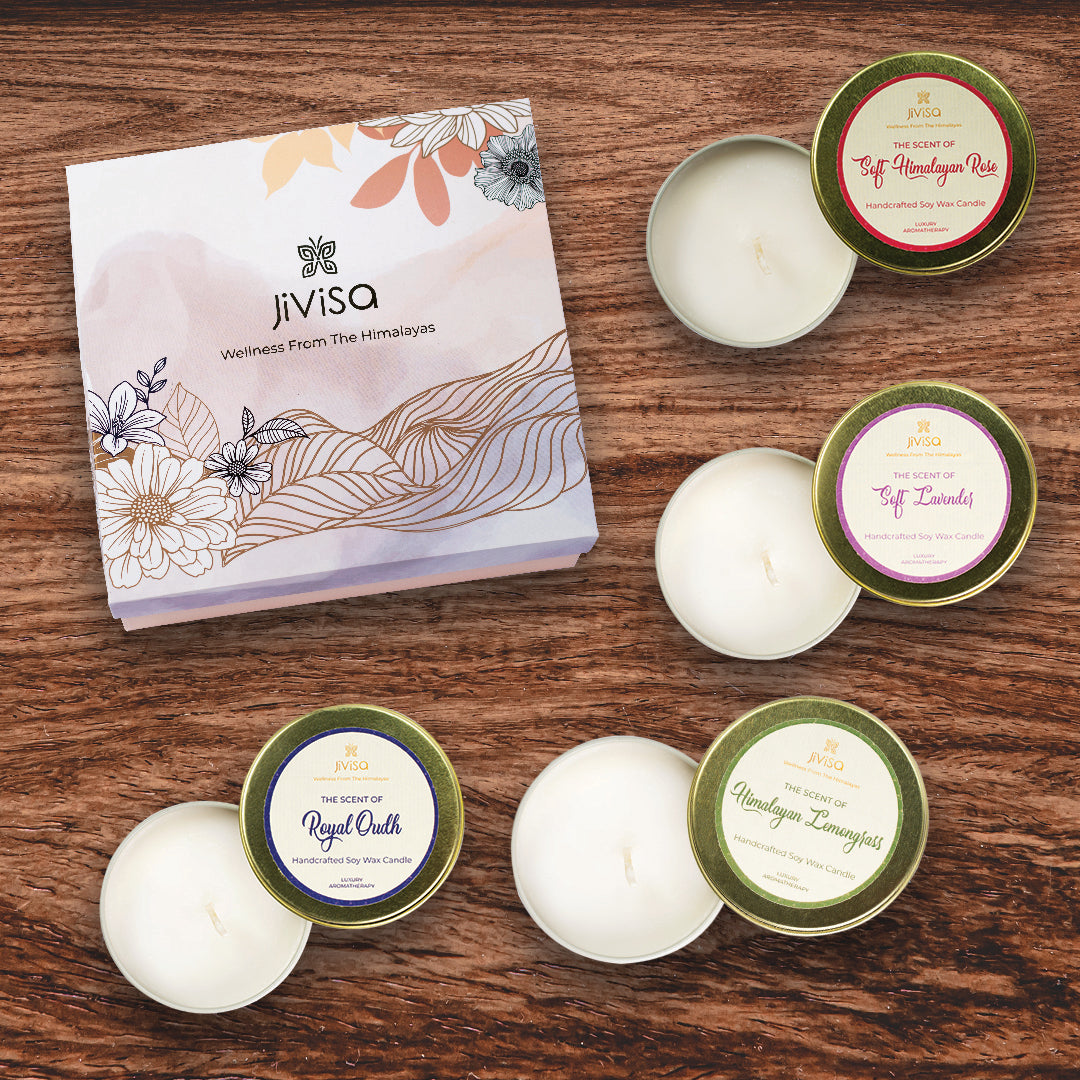 JiViSa Luxury Soy Wax Candle Gift Box with floral packaging placed near four handcrafted soy wax candles including calming Soft Lavender to ease stress, warm and woody Royal Oudh for a touch of Arabian luxury, romantic Soft Himalayan Rose, and refreshing Himalayan Lemongrass, all in elegant gold tins.