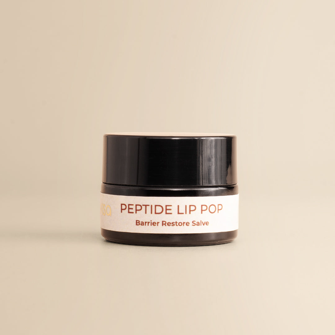 JiViSa Peptide Lip Pop Barrier Restore Salve Bourbon-Vanilla jar on beige background.