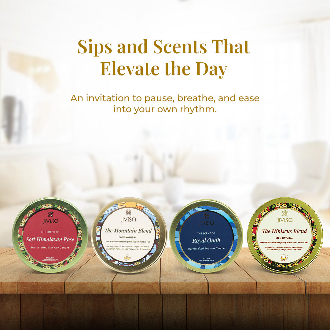 Text on the image reads: "Sips and Scents That Elevate the Day – An invitation to pause, breathe, and ease into your own rhythm" followed by a close-up shot of all four round tins— two Ayurvedic loose leaf teas (The Hibiscus Blend and The Mountain Blend) and two handcrafted soy wax candles (Soft Himalayan Rose and Royal Oudh)—neatly placed on a wooden table.