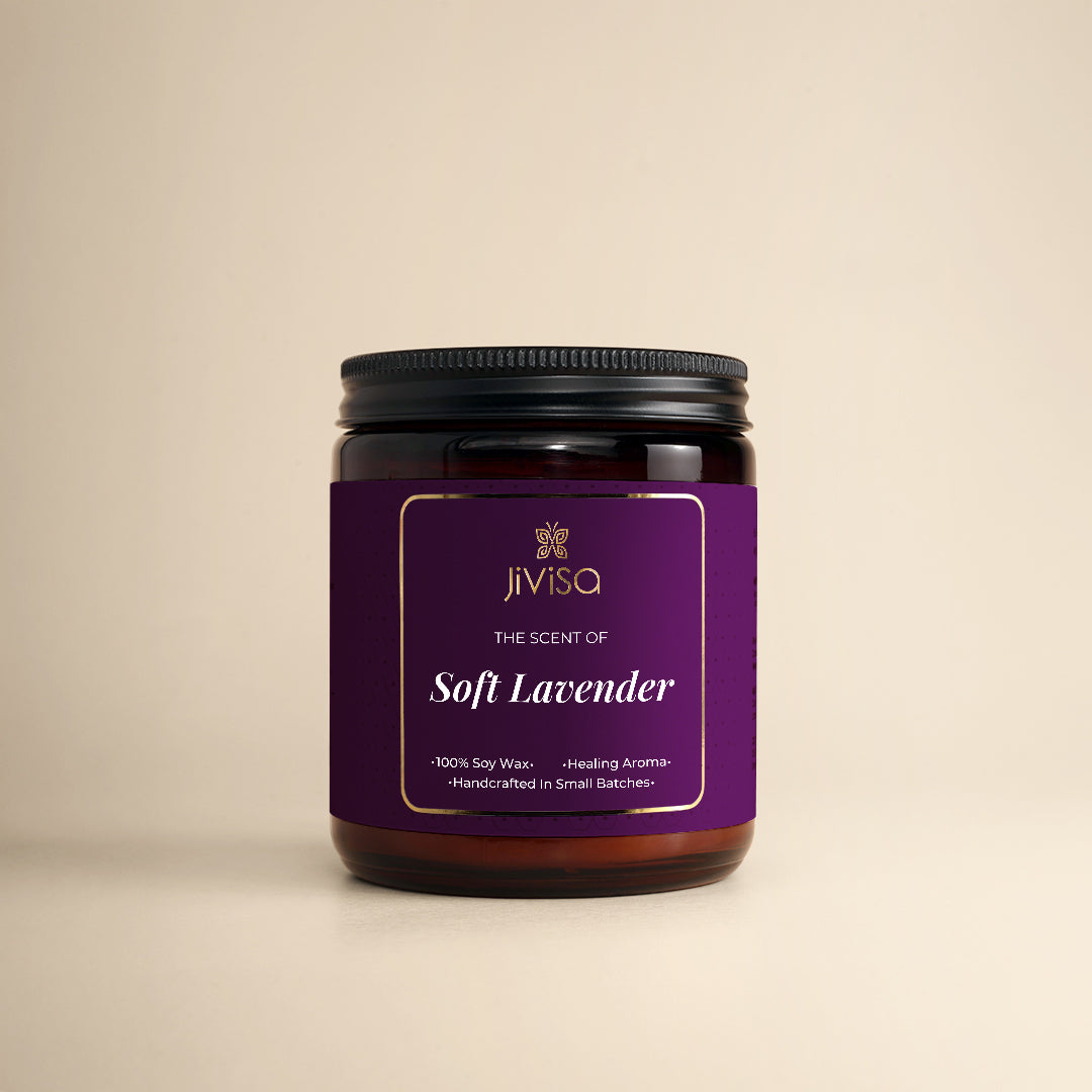 JiViSa Soft Lavender Handcrafted Soy Wax Candle 180gm in an amber glass jar with a Black tin and purple label. The label reads: "JiViSa Wellness From The Himalayas, THE SCENT OF Soft Lavender, Handcrafted 100% Soy Wax Candle, Healing Aroma".