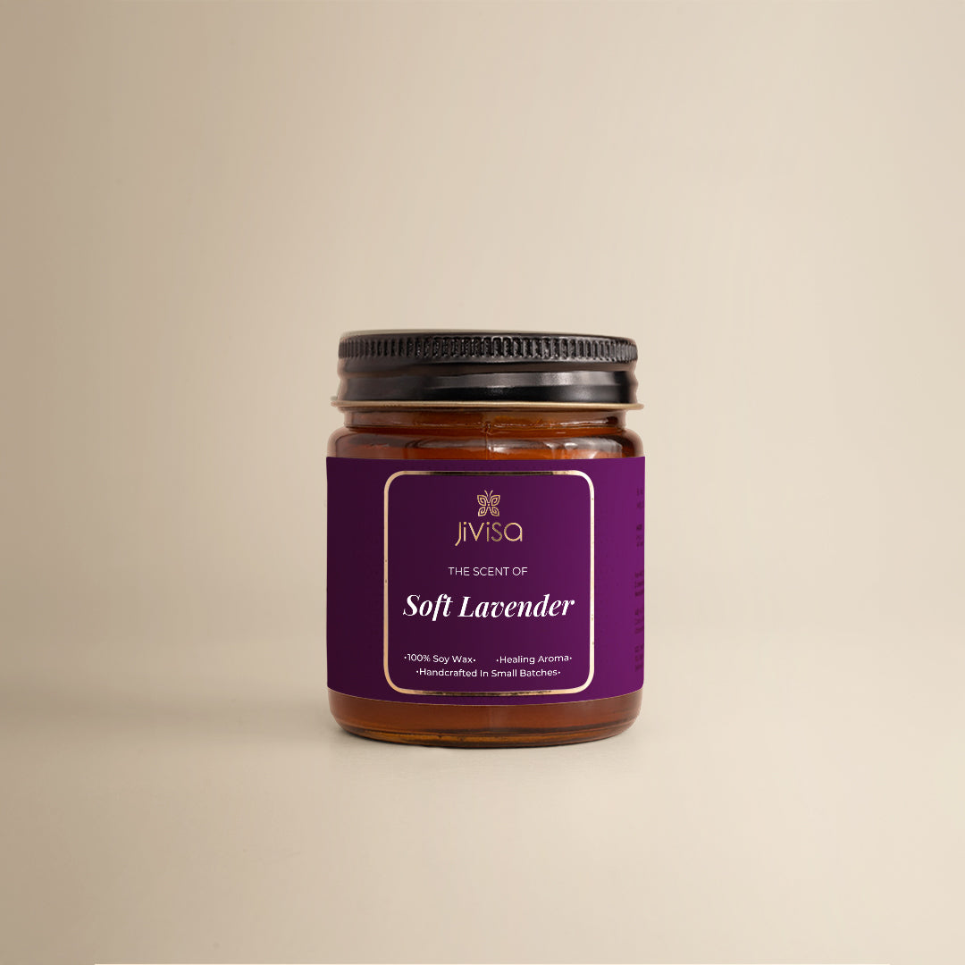 JiViSa Soft Lavender Handcrafted Soy Wax Candle 90gm in an amber glass jar with a Black tin and purple label. The label reads: "JiViSa Wellness From The Himalayas, THE SCENT OF Soft Lavender, Handcrafted 100% Soy Wax Candle, Healing Aroma".