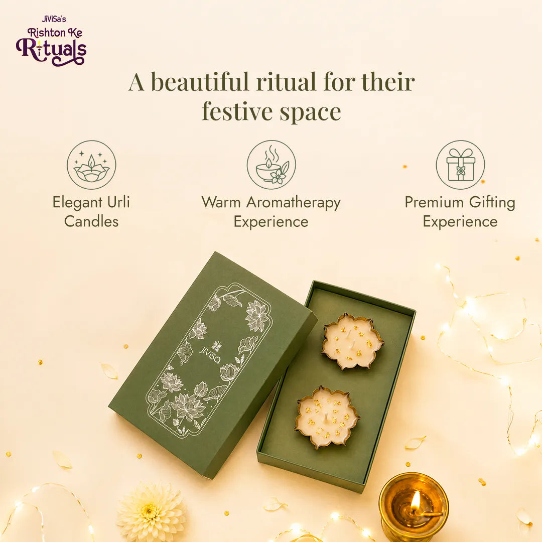 Urli Elegance Aroma Box opened for festive gifting, showing two urli candles in sage green packaging with fairy lights and a diya