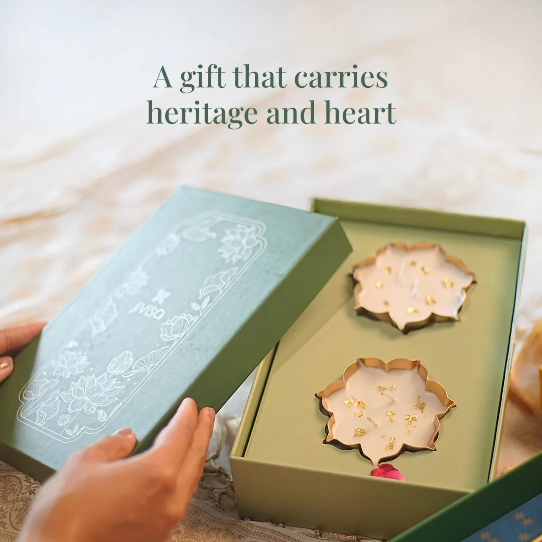 JiViSa Urli Elegance Aroma Box opened to reveal two lotus-shaped gold-rimmed candles nestled in green gift packaging with floral embossed lid