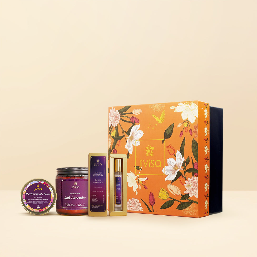 JiViSa Twilight Calm Tea & Aroma Collection gift box, featuring a soft lavender soy wax candle glass jar, raina slumber pillow mist, and tranquility blend tea tin. The orange box has a beautiful floral design, set against a warm, neutral background.