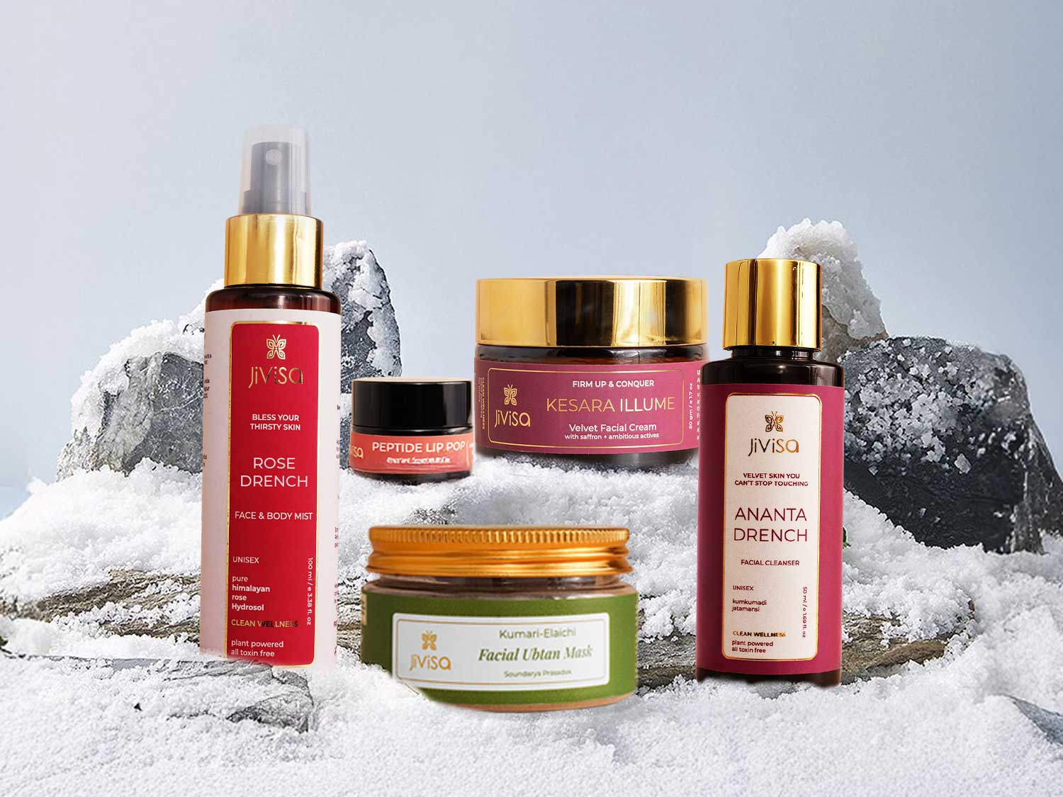 JiViSa winter glow skincare set arranged on snow, featuring cleanser, mist, cream, ubtan and lip balm that deeply hydrate, nourish, brighten and protect skin from winter dryness.