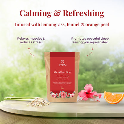 The image showcases a package of the JiViSa-The Hibiscus Blend Herbal Tea surrounded fresh lemongrass, fennel seeds, an orange slice, and a pink hibiscus flower. The tagline reads: &quot;Calming &amp; Refreshing&quot;. The text highlights that the tea is Infused with lemongrass, fennel &amp; orange peel, and points out its benefits with curved arrows leading to the Relaxes muscles &amp; reduces stress and Promotes peaceful sleep, leaving you rejuvenated.