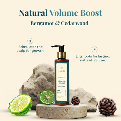 The image showcases JiViSa Aranya Boost Hair Cleanser, Natural Volume Boost Hair Cleanser with Bergamot &amp; Cedarwood. The text highlights that this cleanser stimulates the scalp for growth and lifts roots for lasting, natural volume. The product is presented on a textured stone-like surface, flanked by fresh bergamot fruits and cedarwood cones, emphasizing its natural ingredients. 