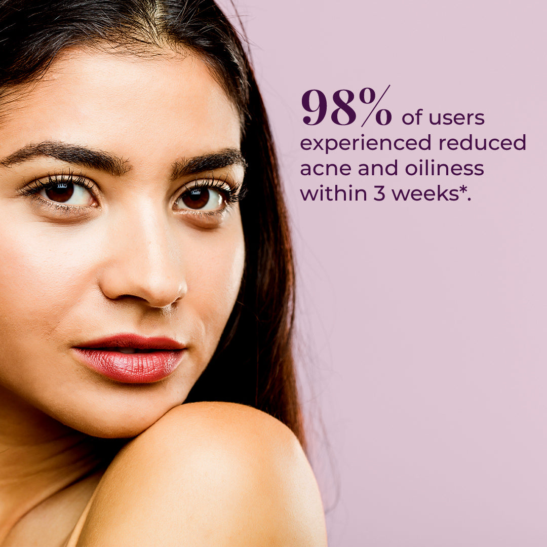 Close-up of a young woman with clear skin, representing effects of JiViSa- Nimba Tulsi facial Ubtan. To the right of her face, text states 98% of users experienced reduced acne and oiliness within 3 weeks*. The background is a soft.