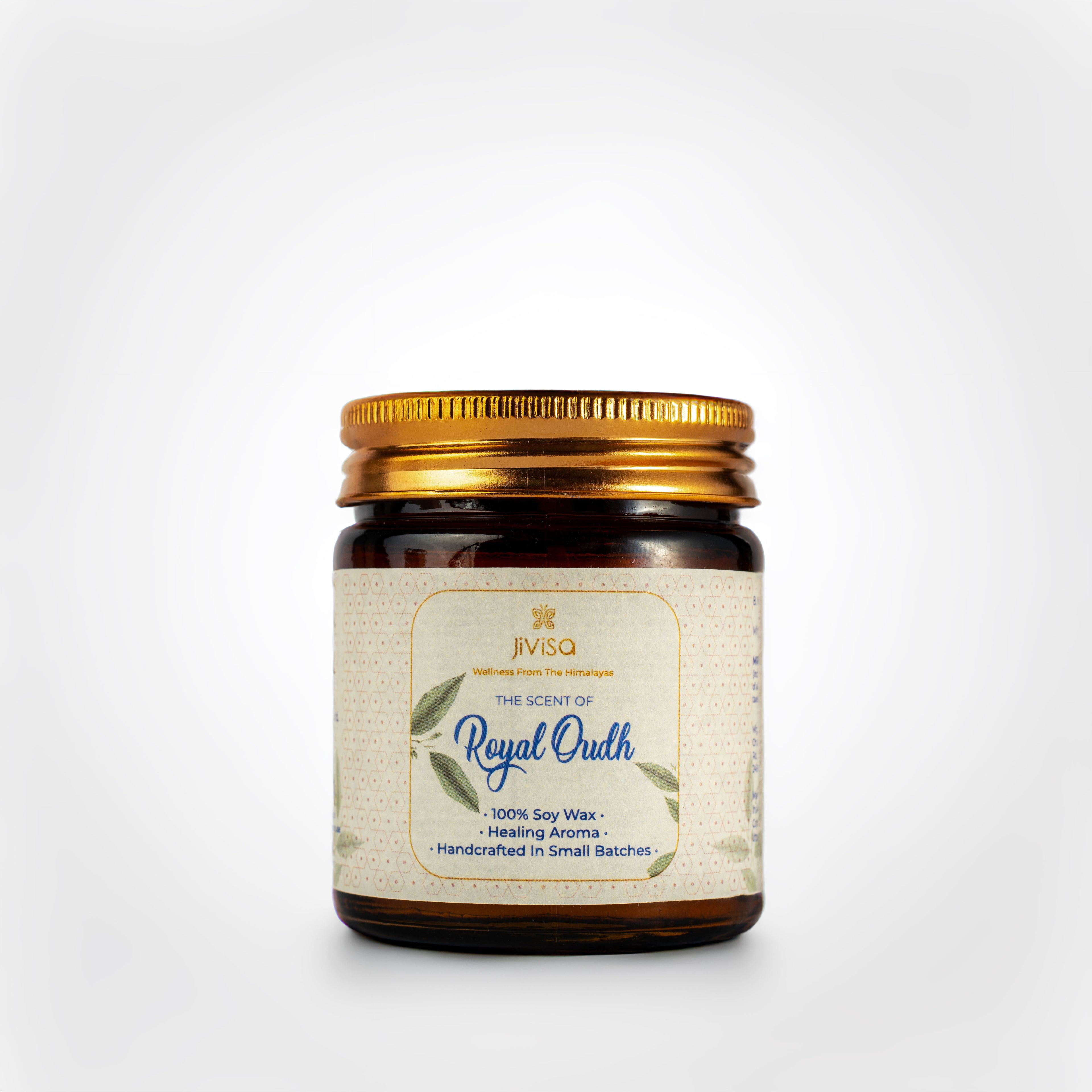 JiViSa Royal Oudh Handcrafted Soy Wax Candle 90gm in an amber glass jar with a Golden tin and white label.  The label reads: &quot;JiViSa Wellness From The Himalayas, THE SCENT OF Royal Oudh, 100% Soy Wax Candle, Healing Aroma, Handcrafted in Small Batches&quot;.