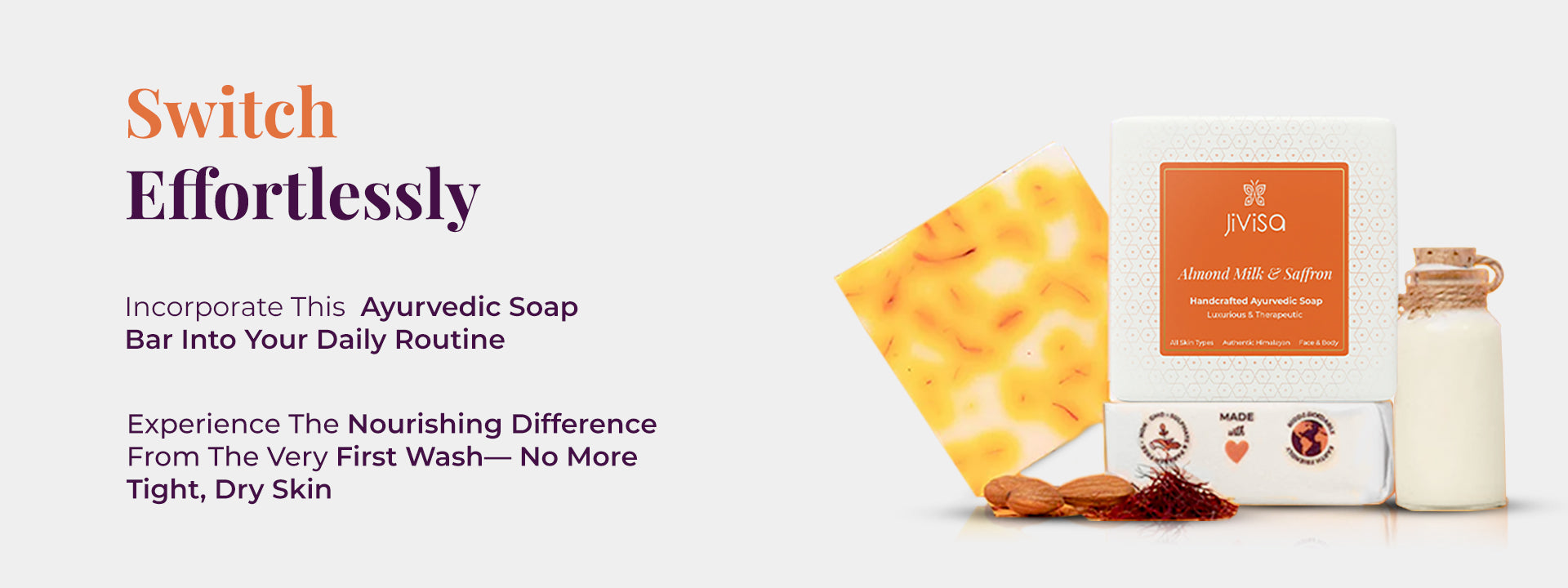 JiViSa Almond Milk & Saffron Ayurvedic Handmade Soap bar and its box with saffron strands is shown alongside almonds, a bottle of almond milk, and saffron strands. On the left, the tagline reads: “Switch Effortlessly” followed by the text 'Incorporate This Ayurvedic Soap Bar Into Your Daily Routine', and 'Experience The Nourishing Difference From The Very First Wash—No More Tight, Dry Skin.' 