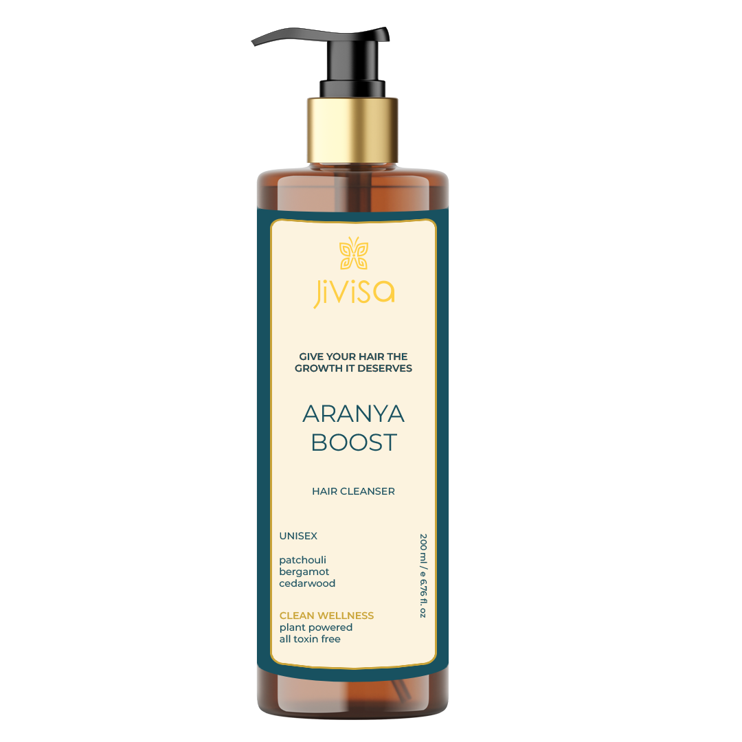  this amber bottle with a gold pump features the "JiViSa" logo and the tagline "GIVE YOUR HAIR THE GROWTH IT DESERVES." The product name "ARANYA BOOST HAIR CLEANSER" is clearly displayed, along with the same key ingredients and wellness claims