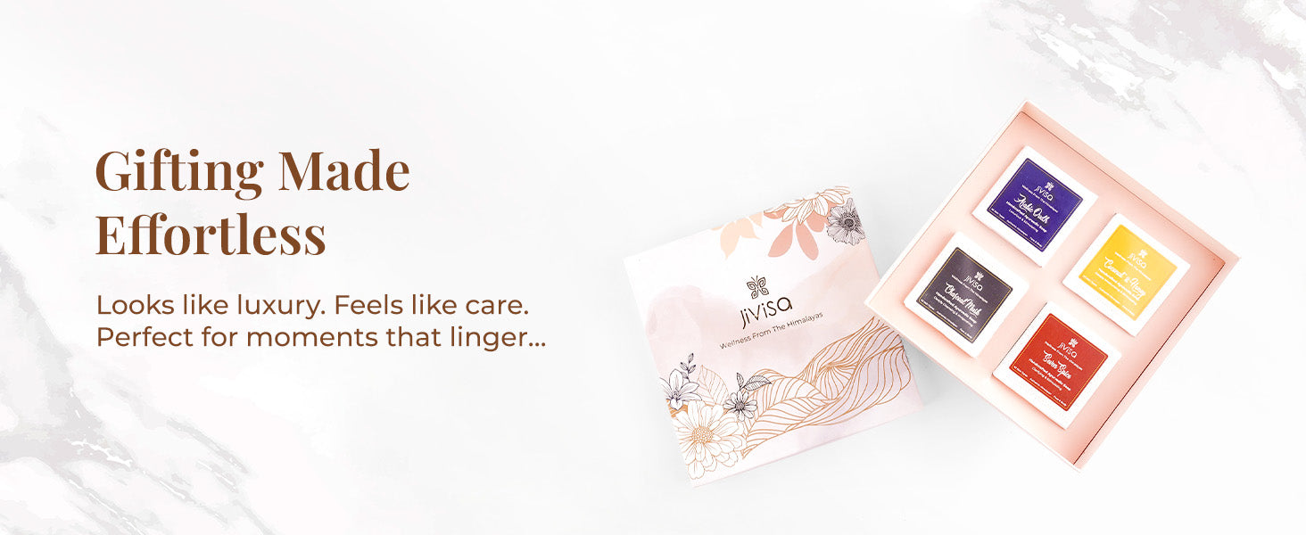 Text on the image reads: "Gifting Made Effortless" - Looks like luxury. Feels like care. Perfect for moments that linger.... An open top-down view of the JiViSa Ayurvedic Glow Soap gift box featuring four variants of JiViSa Handcrafted Ayurvedic soap bars arranged neatly.

