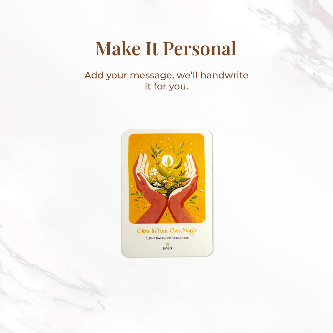 &quot;Make it personal – We’ll handwrite your message for you.&quot; A handwritten card with warm yellow and orange tones shows two hands holding blooming herbs with a glowing sun. Placed on a white surface, the image emphasizes the personal, heartfelt gifting experience JiViSa offers.