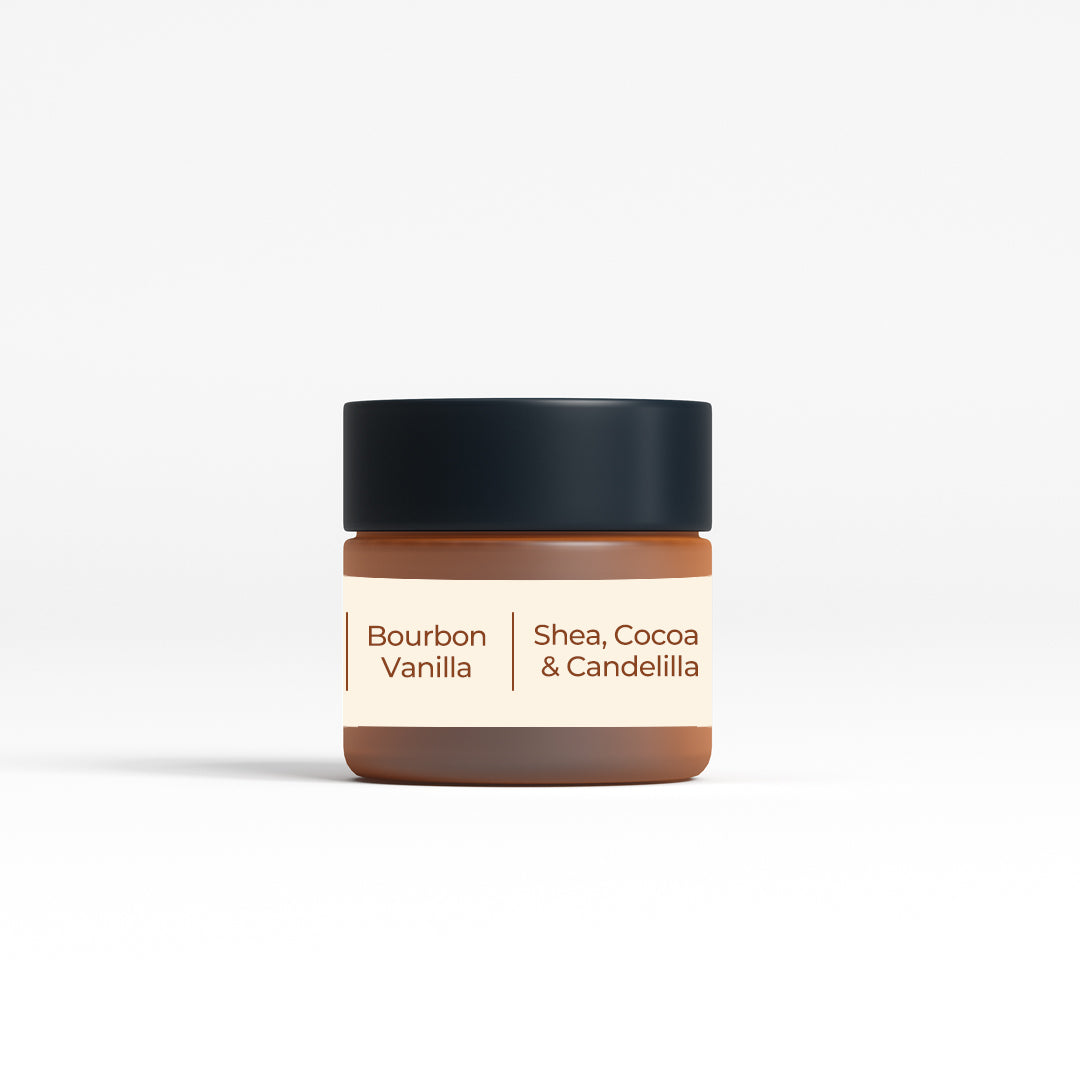 Back view of JiViSa Bourbon Vanilla Peptide Lip Lop lip balm jar. The label highlights the key ingredients: Shea, Cocoa, and Candelilla, emphasizing the natural and nourishing components of the lip balm. The jar's design complements its premium and effective formulation, suitable for everyday use.