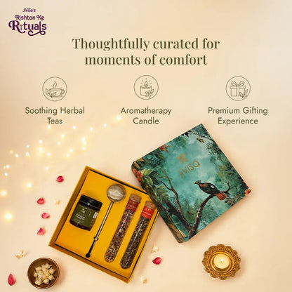 JiViSa Brew n Bliss gift set open beside its teal peacock lid, with lemongrass candle, gold infuser and two herbal tea tubes, styled with diyas. Thoughtfully curated for moments of comfort.