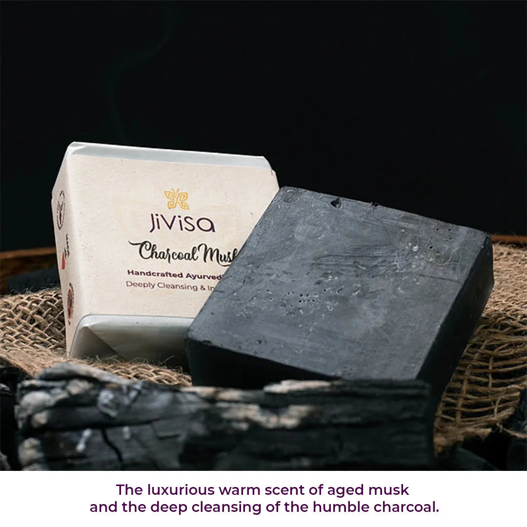 JiViSa Charcoal Musk soap bar on burlap with charcoal pieces, showing deep cleansing and warm musk scent