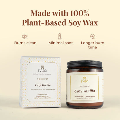 This image features both JiViSa Cozy Vanilla candle amber glass jar and its elegant white and gold-printed outer box against a soft beige background. The text at the top reads: &quot;Made with 100% Plant-Based Soy Wax.&quot; Three icons below highlight: &quot;Burns clean,&quot; &quot;Minimal soot,&quot; and &quot;Longer burn time.&quot; The box and jar both label reads: &quot;JiViSa – The Scent of Cozy Vanilla – Aromatherapy Soy Wax Candle – Handpoured • Healing Aroma • 100% Premium Soy Wax.&quot;