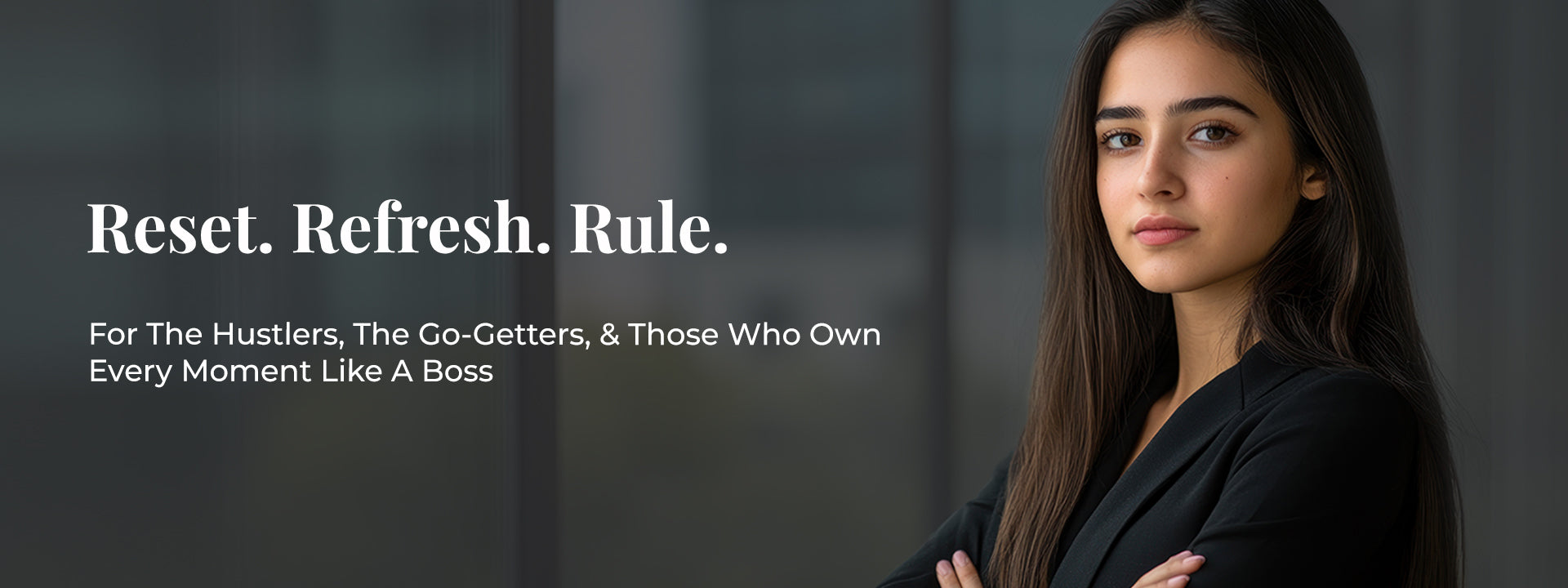 Confident woman in a black blazer standing with arms crossed against a modern glass office backdrop. Bold white headline reads “Reset. Refresh. Rule.” followed by subtext: “For the hustlers, the go-getters, & those who own every moment like a boss.” Visual represents the empowered mood of JiViSa Charcoal Musk Ayurvedic Handmade Soap—crafted to leave skin feeling luxurious, fresh, and ready to rule.