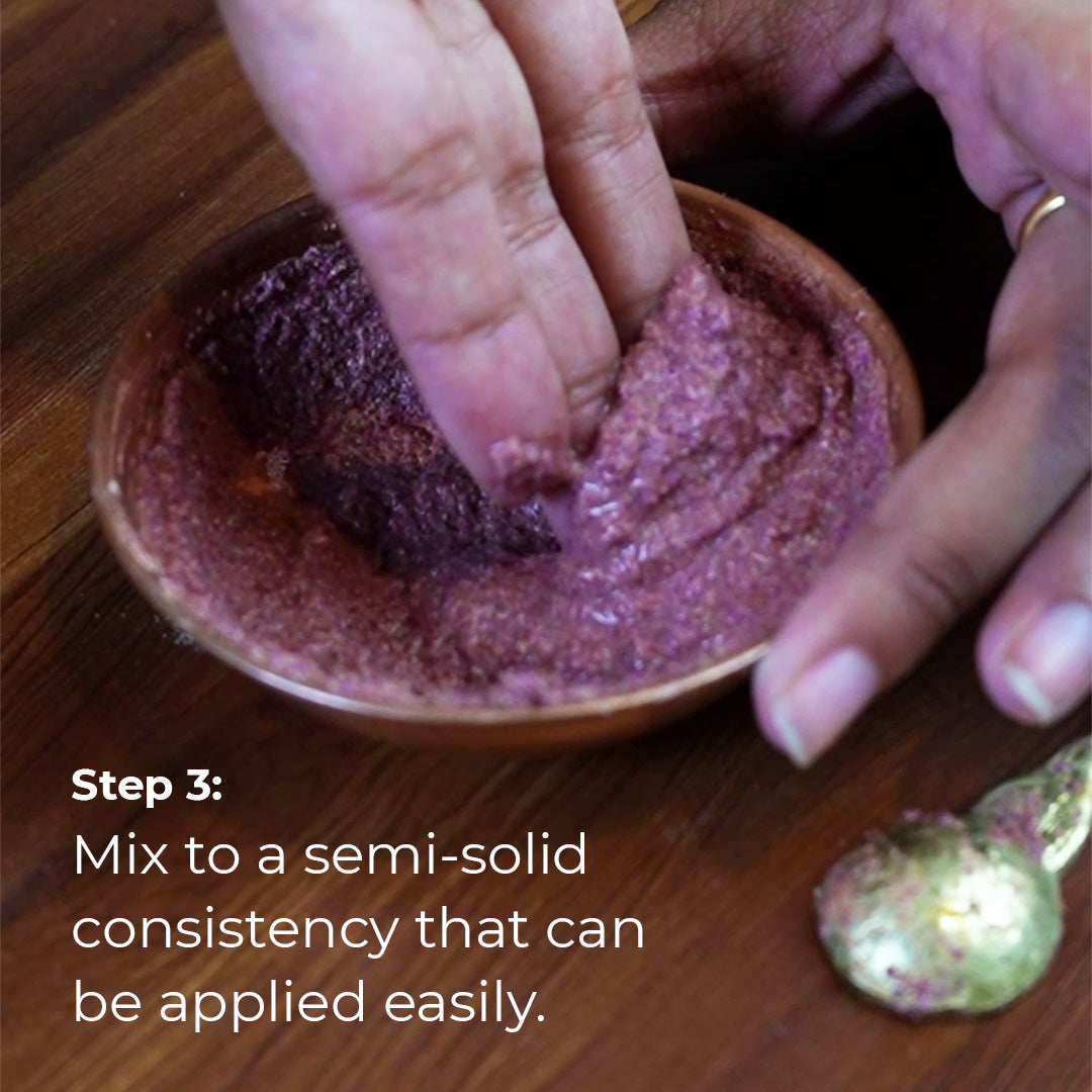 Two hands mixing a purple, semi-solid paste in a small copper bowl. The texture appears slightly grainy. Text overlay reads &quot;Step 3: Mix to a semi-solid consistency that can be applied easily.&quot;