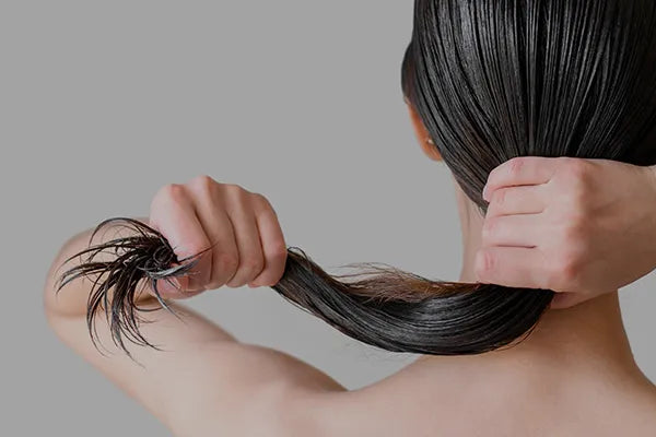 Woman running fingers through smooth, healthy hair – Hair Care category