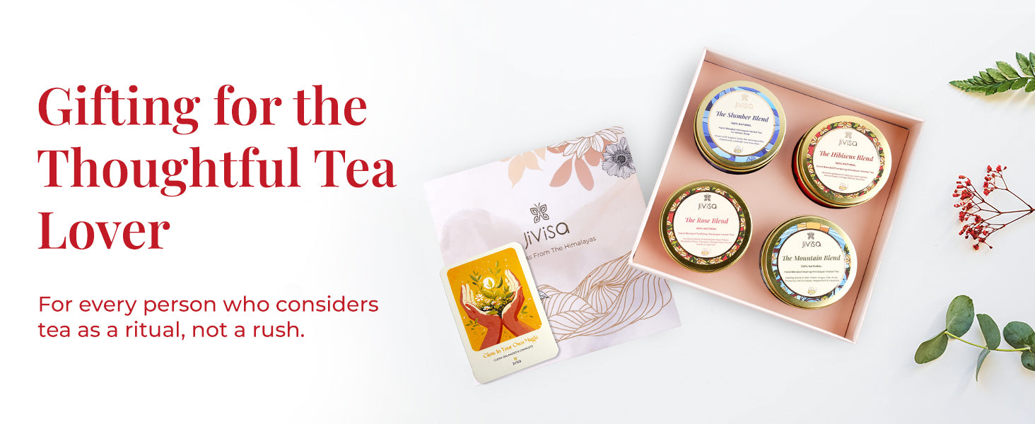 Flat lay of the JiViSa Himalayan Discovery Tea Gift Box, open to display four variant of JiViSa tea blends: The Hibiscus Blend, The Slumber Blend, The Rose Blend, and The Mountain Blend. The floral-illustrated box is paired with a handwritten personalized card. Tagline reads: "Gifting for the Thoughtful Tea Lover." Supporting text: For every person who considers tea as a ritual, not a rush.