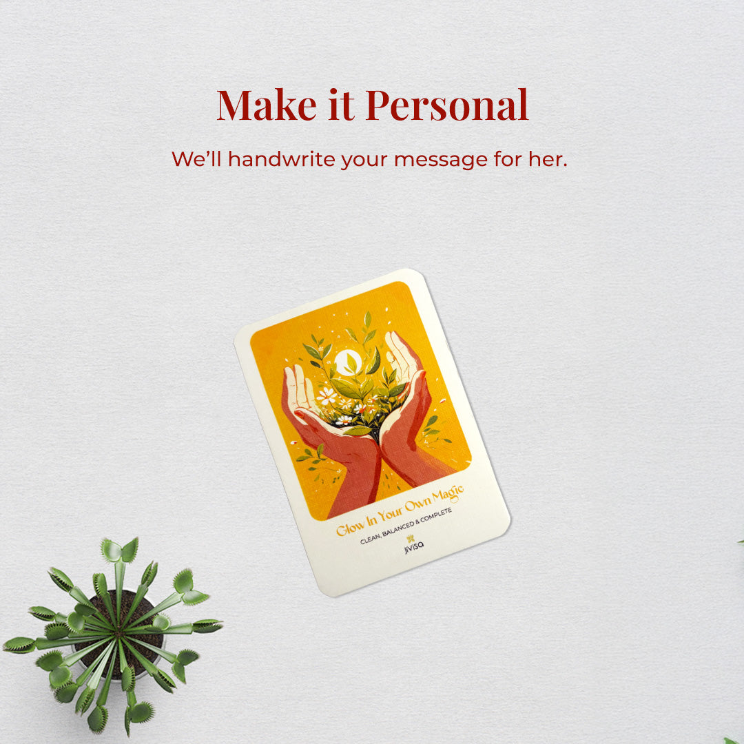 &quot;Make it personal – We’ll handwrite your message for you.&quot; A handwritten card with warm yellow and orange tones shows two hands holding blooming herbs with a glowing sun. Placed on a white surface, the image emphasizes the personal, heartfelt gifting experience JiViSa offers.