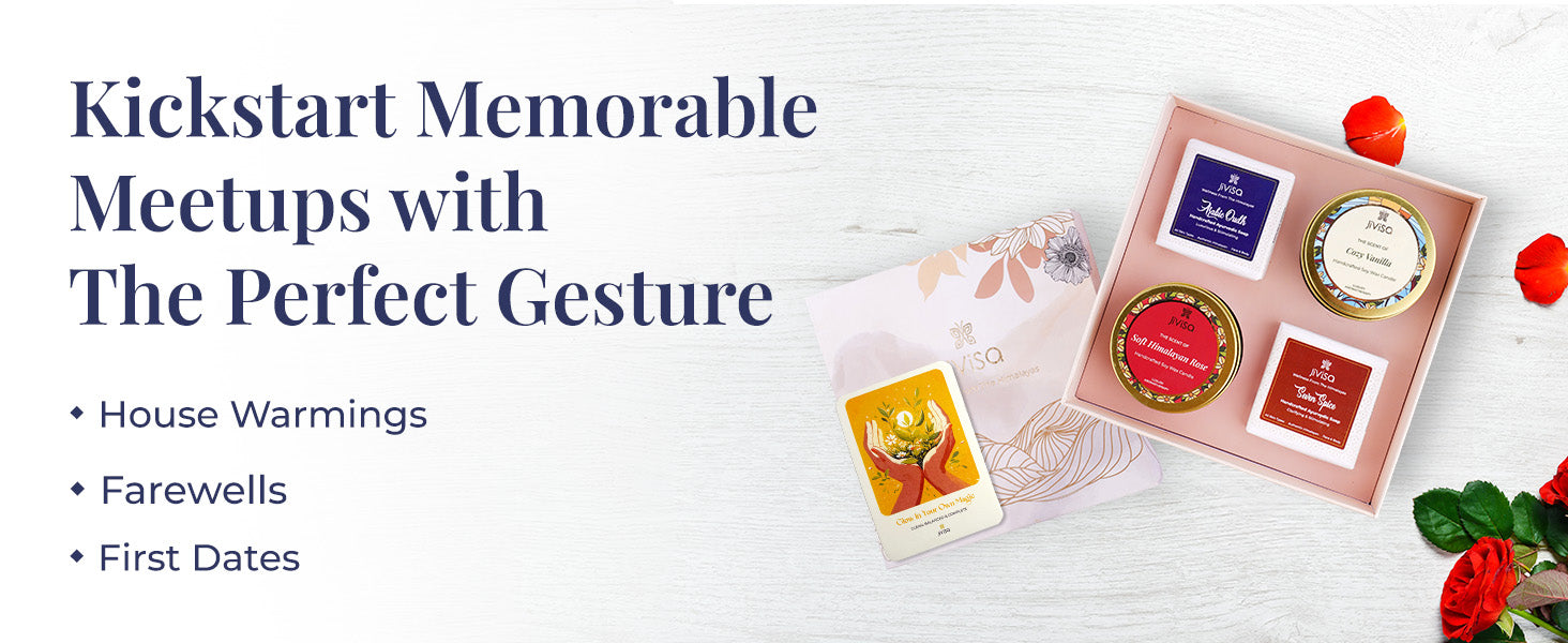 JiViSa Himalayan Rituals Gift Box open, displaying two JiViSa handcrafted soaps—Arabic Oudh and Seven Spice—and two soy wax candles—Royal Oudh and Soft Himalayan Rose—arranged with an affirmation gift card and surrounded by scattered red rose petals. Tagline on the left reads: “Kickstart Memorable Meetups with The Perfect Gesture.” Bullet points list: House Warmings | Farewells | First Dates.
