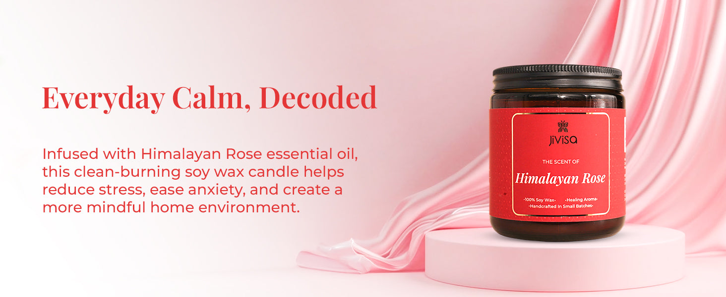 JiViSa Himalayan Rose Soy Wax Candle on a pink circular base with pink silk fabric in the background. Tagline reads: “Everyday Calm, Decoded.” Body text: “Infused with Himalayan Rose essential oil, this clean-burning soy wax candle helps reduce stress, ease anxiety, and create a more mindful home environment.” Candle label reads: “JiViSa – The Scent of Himalayan Rose – 100% Soy Wax • Healing Aroma • Handcrafted in Small Batches.”