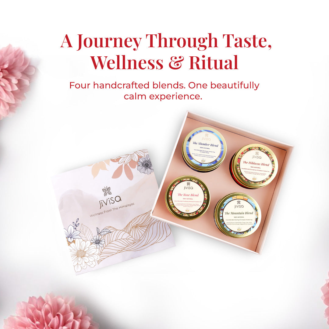 Text on the image reads:"A Journey Through Taste, Wellness &amp; Ritual – Four handcrafted blends. One beautifully calm experience." The open gift box is displayed from a top angle, containing four labeled JiViSa handmade herbal tea tins. The soft pink background and floral accents create a calming and luxurious visual atmosphere, perfect for wellness rituals.