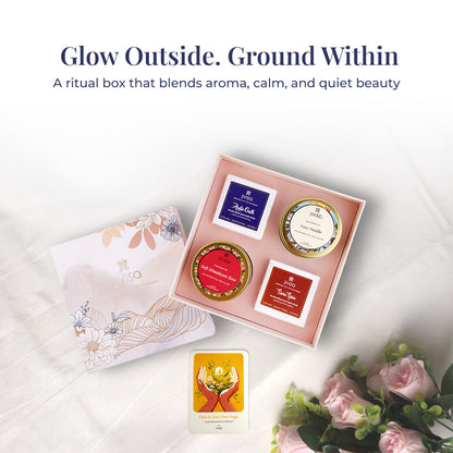 Text on image reads: &quot;Glow Outside. Ground Within&quot; – A ritual box that blends aroma, calm, and quiet beauty. A styled top-view of the open JiViSa Himalayan Ritual Soap &amp; Candle gift box revealing all four ritual products includes Royal Oudh &amp; Soft Himalayan Rose Candles, Seven Spice &amp; Arabic Oudh Soaps, alongside the illustrated &quot;Glow In Your Own Magic&quot; handwritten gift card. The setup is surrounded by soft roses and white fabric, evoking relaxation, aroma, and self-care.