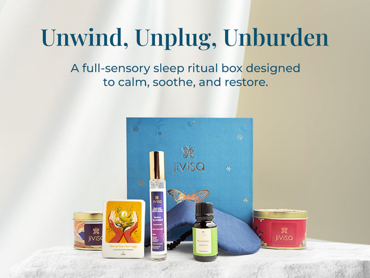 JiViSa Dreamscape Relaxation Aroma Gift Set elegant blue box contains JiViSa Herbal Tea Blend, JiViSa Premium Soy Wax Candle, JiViSa Palmarosa Essential Oil, JiViSa Raina Slumber Pillow Mist, and a soft blue eye mask paired with a handwritten illustrated gift card. Tagline reads: "Unwind, Unplug, Unburden." Supporting text: A full-sensory sleep ritual box designed to calm, soothe, and restore.
