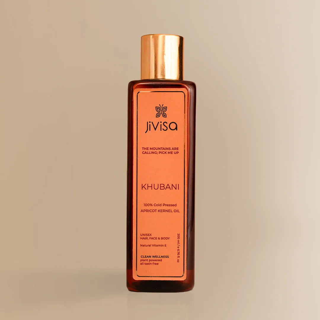 JiViSa Khubani Apricot Kernel Oil 200ML bottle with gold cap on beige background.