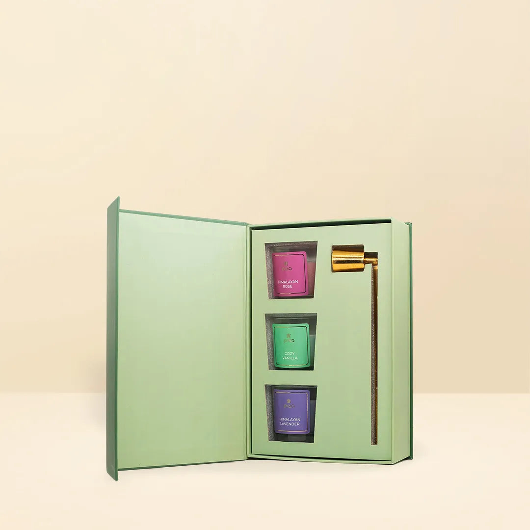 JiViSa Lotus Votive Gift Box open book-style green case with three mini scented votive candles in pink, green, and purple, plus a gold Premium Brass Candle Snuffer