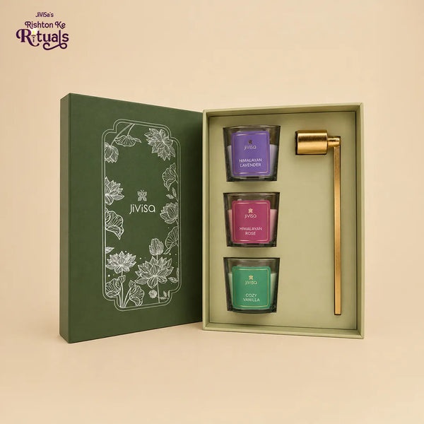 JiViSa Lotus Light votive candle gift set open, showing three soy wax votives and a brass candle snuffer in a green lotus box