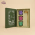 JiViSa Lotus Light votive candle gift set open, showing three soy wax votives and a brass candle snuffer in a green lotus box