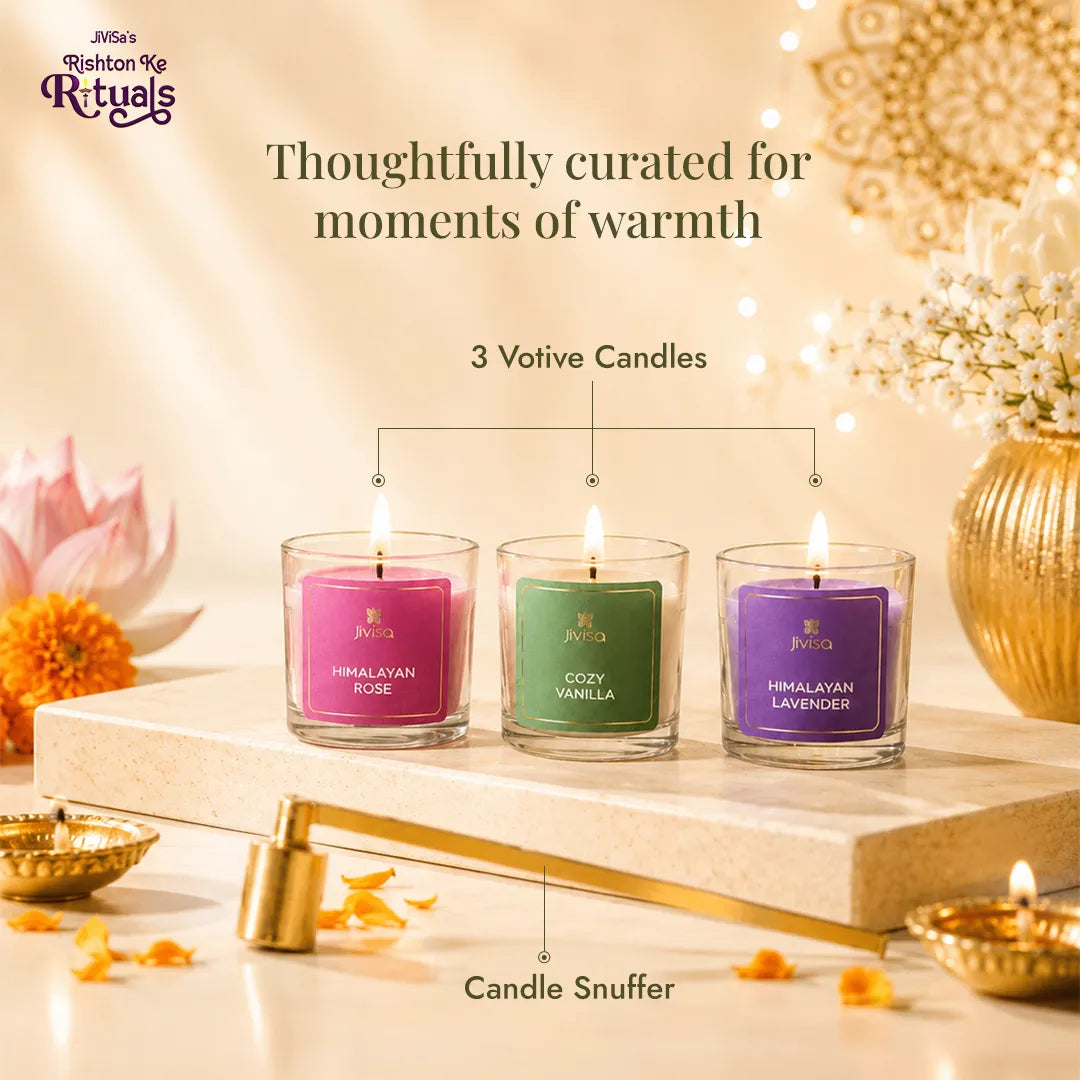 Three lit JiViSa votive candles - Himalayan Rose, Cozy Vanilla, Himalayan Lavender with a brass candle snuffer