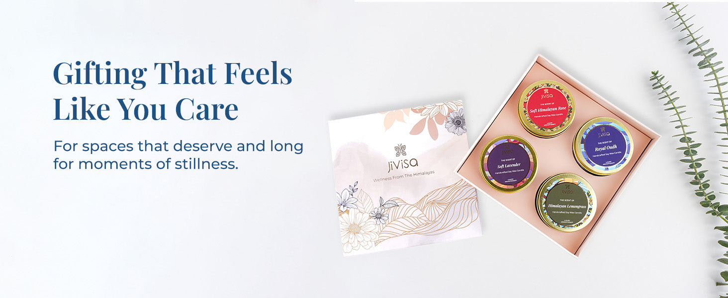 JiViSa Luxury Soy Wax Candle Gift Box open, displaying four variants o JiViSa handcrafted candles—Soft Himalayan Rose, Royal Oudh, Soft Lavender, and Himalayan Lemongrass—styled with its floral outer box and eucalyptus leaves. Tagline on the left reads: “Gifting That Feels Like You Care”, followed by subtext: “For spaces that deserve and long for moments of stillness.”