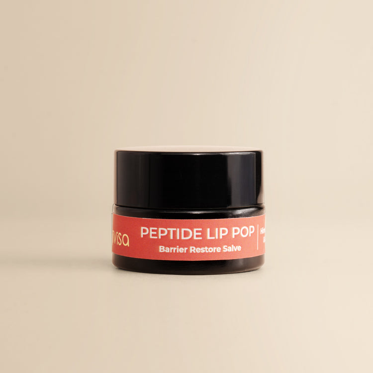 JiViSa Peptide Lip Pop Salve Himalayan Rose &amp; Lavender Barrier Restore Salve jar on beige background.