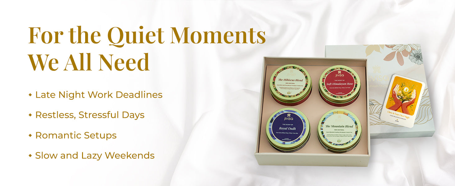 JiViSa Premium Loose Leaf soy wax candle gift box open on soft white fabric, revealing four JiViSa candle tins—The Hibiscus Blend, Soft Himalayan Rose candle, Royal Oudh candle, and The Mountain Blend tea—placed beside the floral lid and an affirmation card. Tagline on left reads: “For the Quiet Moments We All Need” with bullet points: Late Night Work Deadlines | Restless, Stressful Days | Romantic Setups | Slow and Lazy Weekends.