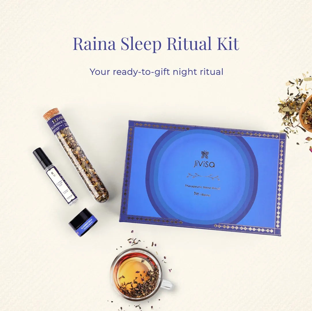 JiViSa Raina Sleep Ritual Kit blue gift box with Slumber Tea, Pillow Mist, and Slumber Balm displayed beside a brewed cup of herbal tea